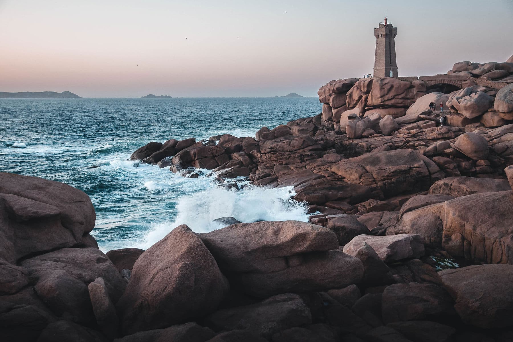 Lighthouse standing on a rocky coast above the ocean
